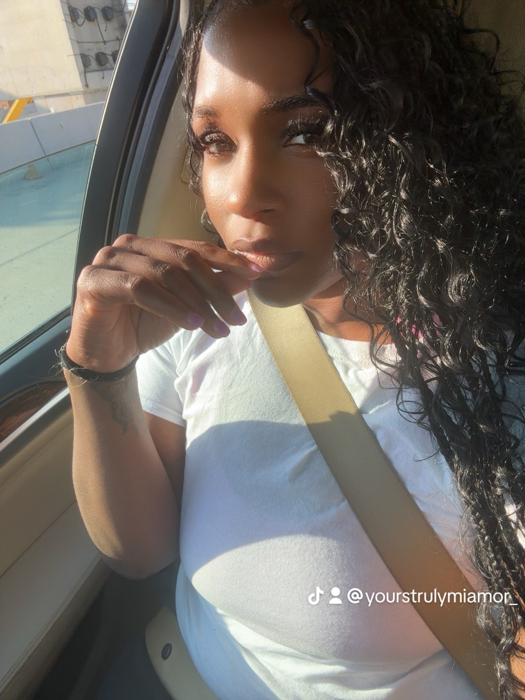 MIAMOR car selfie curly hair white tee